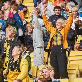 Happy football fans stranding on one of the grandstands at CASA Arena Horsens
