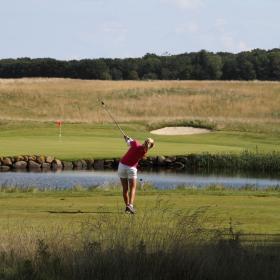 Female golfer on the golf course at Stensballegård Golf Club in Horsens - part of Destination Coastal Land