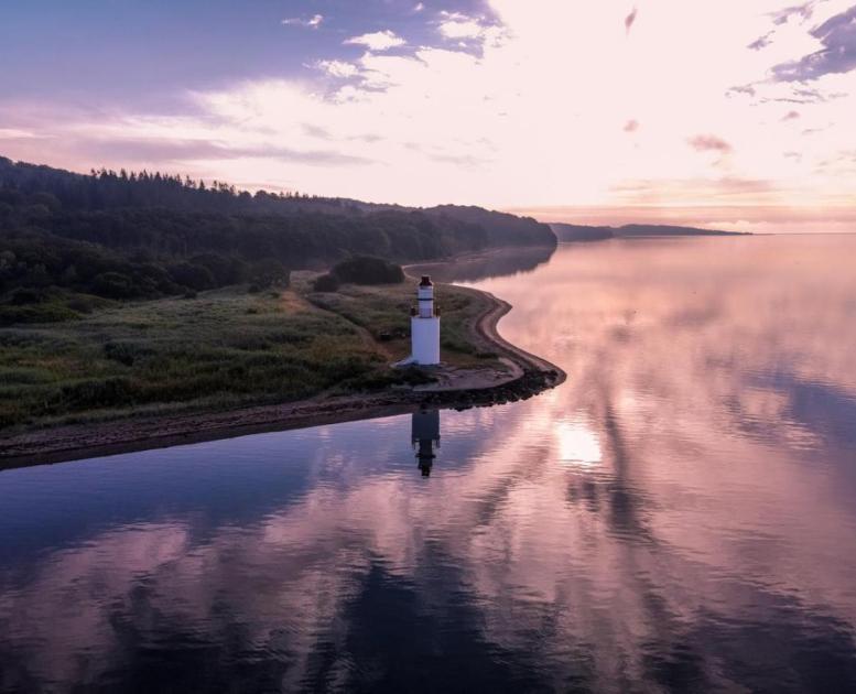 View of the coastal line and lighthouse in the area of Hotel Vejlefjord in the coastal land