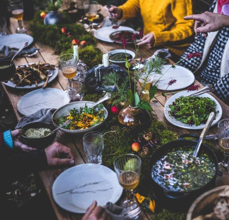 Guests are sitting around a table with food from Sondrup Bed and Breakfast
